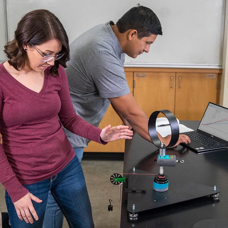 Two students use the Go Direct Centripetal Force Apparatus with a Go Direct Force and Acceleration sensor