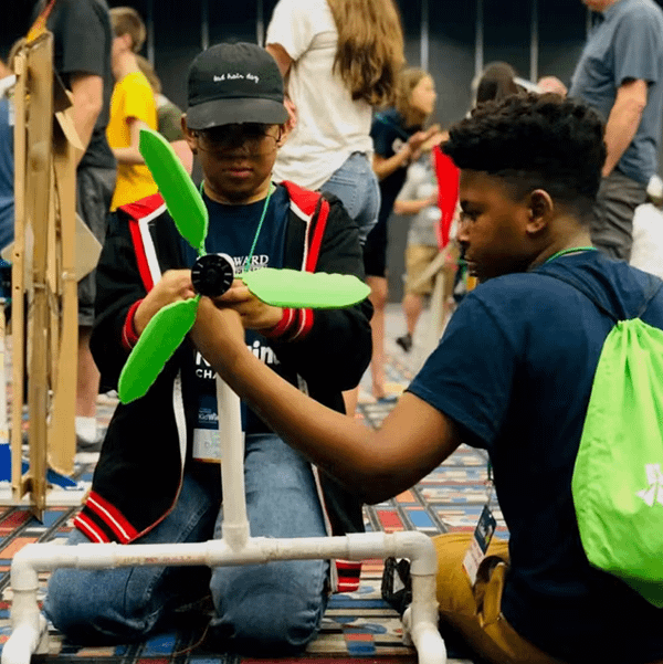 Students adjust their wind turbine design for the competition