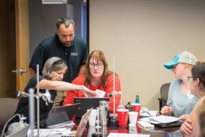 A Vernier instructor guides two educators as they complete a hands-on experiment with Vernier technology