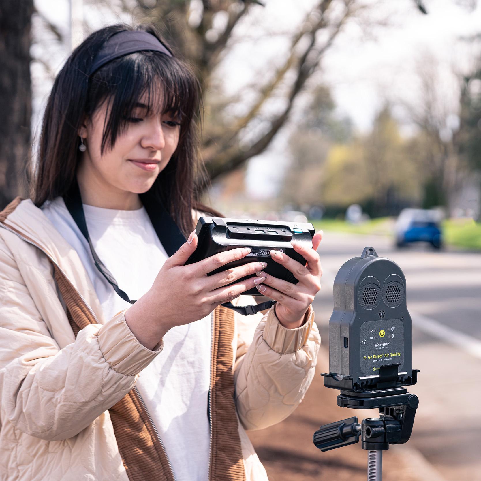 A student collects pollution data from passing cars with the Go Direct Air Quality and LabQuest 3