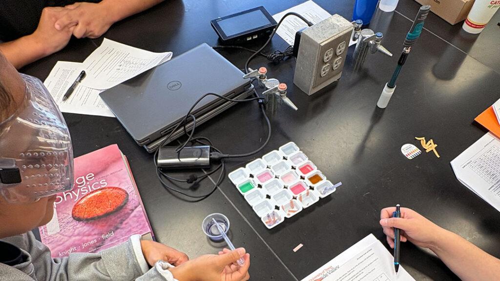 A group of instructors work on an experiment with Go Direct pH.
