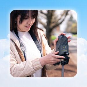 illustration of graphic clouds around a student using the Go Direct Air Quality sensor near the side of a road.