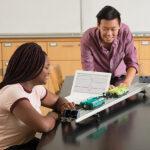 Students investigate kinematics with Go Direct Sensor Carts on a track.