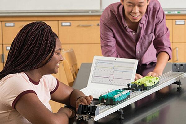 Students investigate kinematics with Go Direct Sensor Carts on a track.