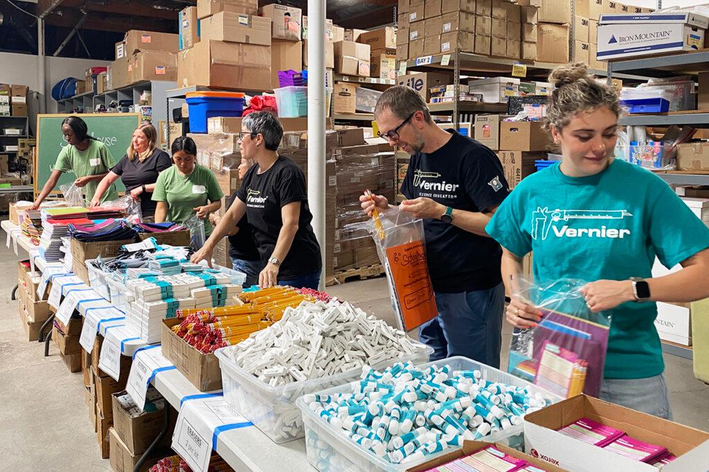 Vernier employees volunteering at Schoolhouse Supplies packing backpacks with supplies for students